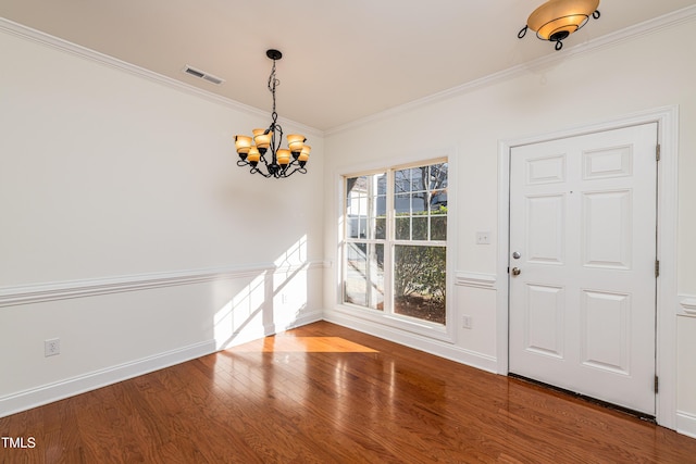 interior space featuring crown molding, a chandelier, and wood-type flooring