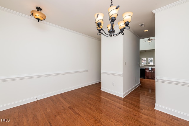 unfurnished dining area featuring ceiling fan with notable chandelier, ornamental molding, and hardwood / wood-style flooring