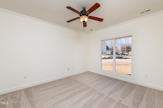 unfurnished room with ceiling fan, crown molding, and light colored carpet