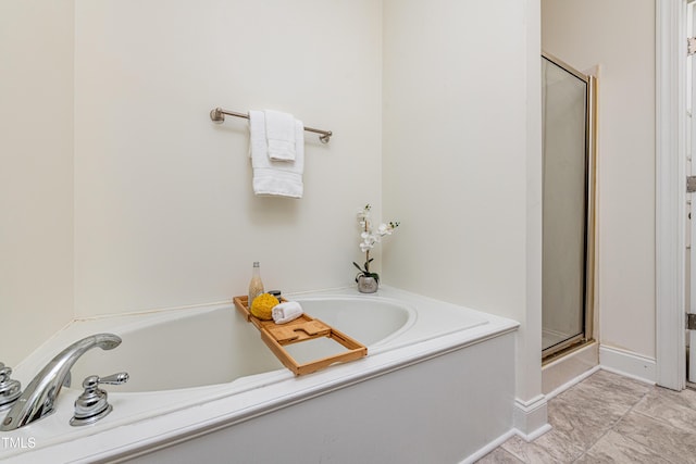 bathroom featuring independent shower and bath