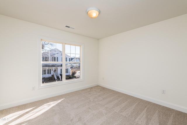 unfurnished room featuring light carpet