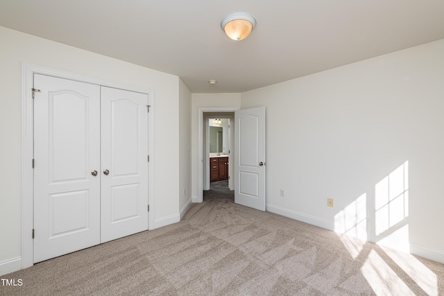 unfurnished bedroom featuring a closet and light carpet