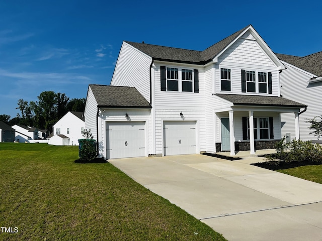 view of front of property featuring a garage, a front yard, and covered porch