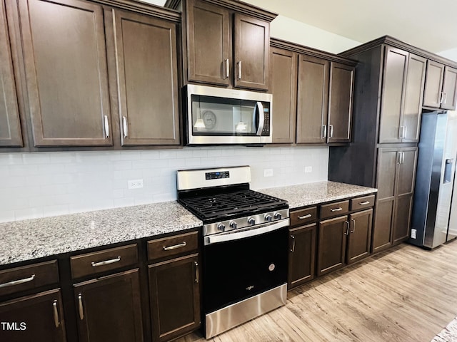 kitchen featuring dark brown cabinetry and stainless steel appliances