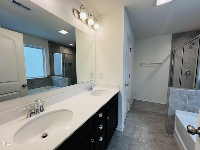 bathroom with vanity and independent shower and bath