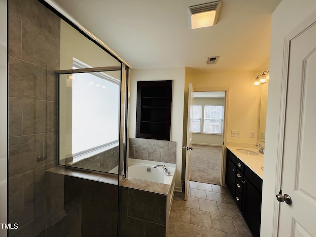 bathroom featuring vanity, tile patterned floors, and shower with separate bathtub