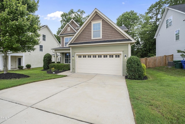 craftsman house featuring a front yard, fence, and driveway