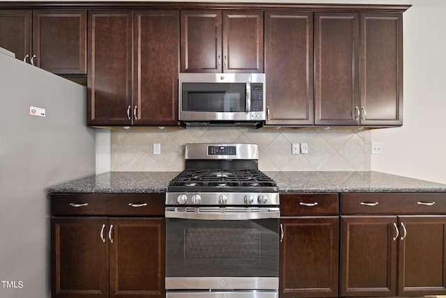 kitchen with tasteful backsplash, dark brown cabinets, and appliances with stainless steel finishes