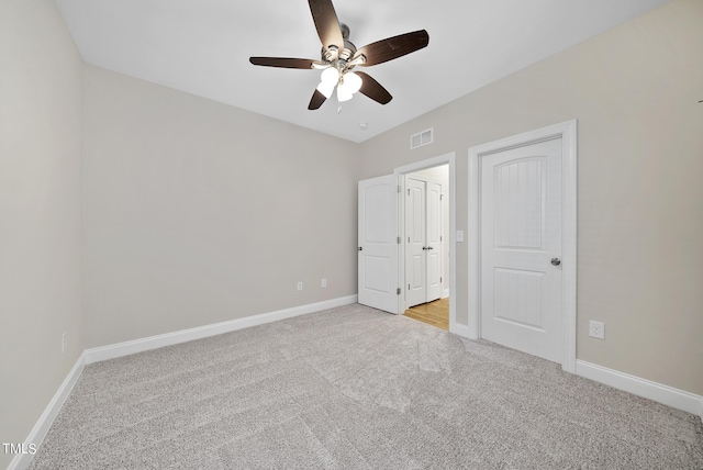 unfurnished bedroom featuring visible vents, carpet flooring, a ceiling fan, and baseboards