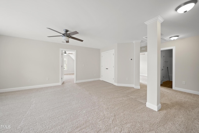 spare room with a ceiling fan, light colored carpet, and baseboards