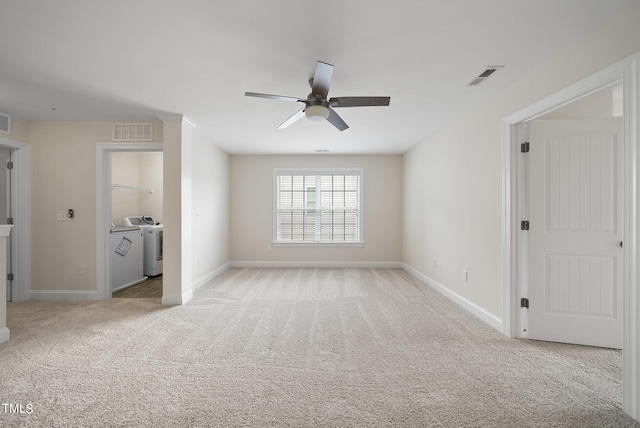 unfurnished bedroom featuring light colored carpet, visible vents, independent washer and dryer, and baseboards