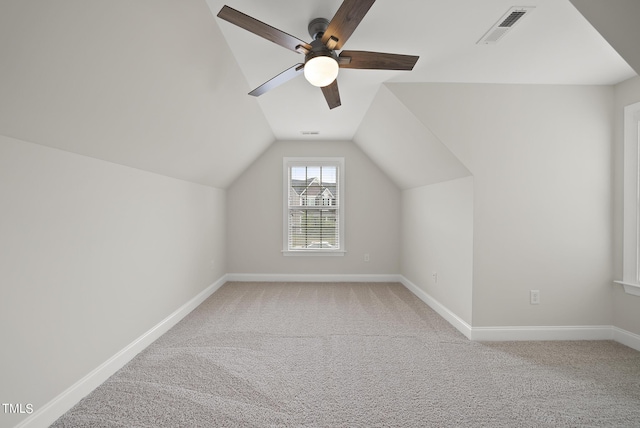 bonus room featuring visible vents, baseboards, carpet, and vaulted ceiling