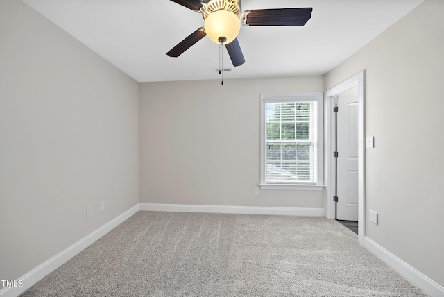 spare room featuring baseboards, carpet, and ceiling fan