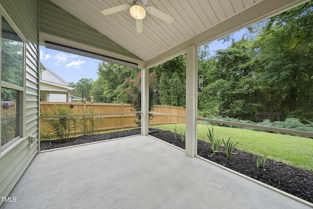 unfurnished sunroom with ceiling fan and vaulted ceiling