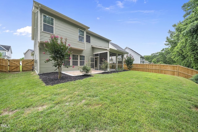 rear view of property with a patio area, a fenced backyard, a yard, and a sunroom