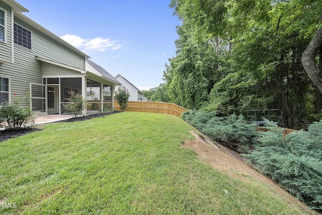 view of yard featuring fence and a sunroom