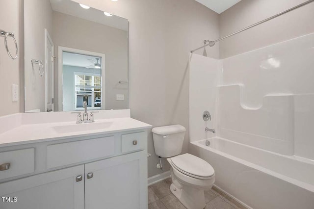 full bathroom featuring ceiling fan, toilet, tile patterned floors, washtub / shower combination, and vanity