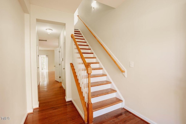 stairs with wood-type flooring