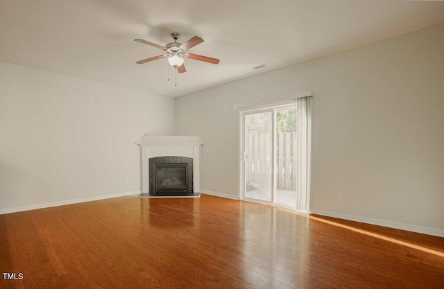 unfurnished living room with a fireplace, ceiling fan, and hardwood / wood-style floors