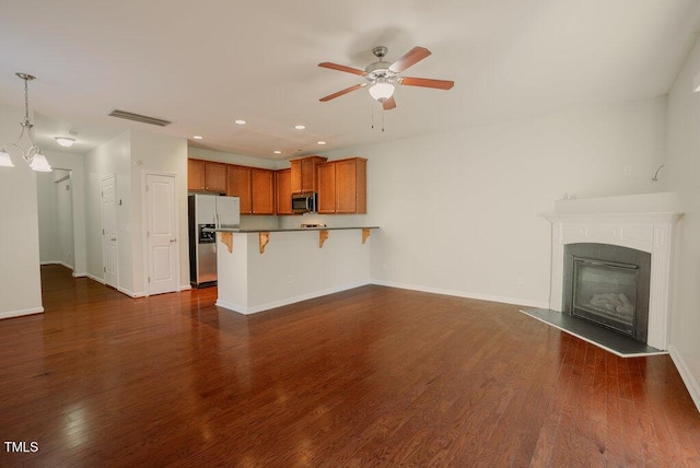 unfurnished living room with ceiling fan and dark hardwood / wood-style floors