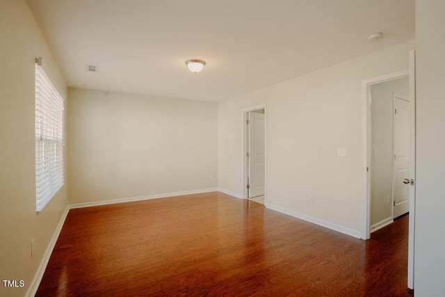 unfurnished room featuring dark wood-type flooring