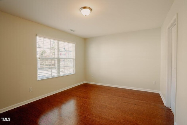 spare room with dark hardwood / wood-style floors