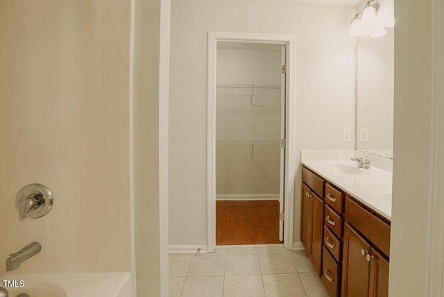 bathroom with a bathing tub, tile patterned floors, and vanity