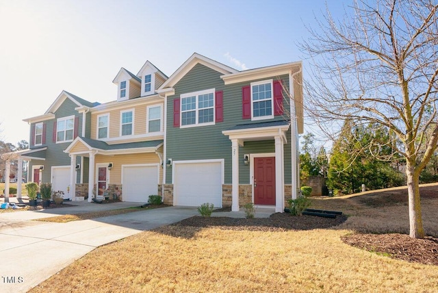 view of property featuring a garage and a front lawn