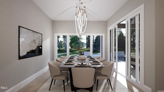 dining room featuring plenty of natural light, light hardwood / wood-style flooring, and a notable chandelier