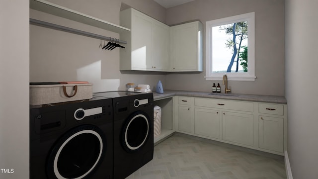 clothes washing area with sink, light parquet floors, cabinets, and independent washer and dryer