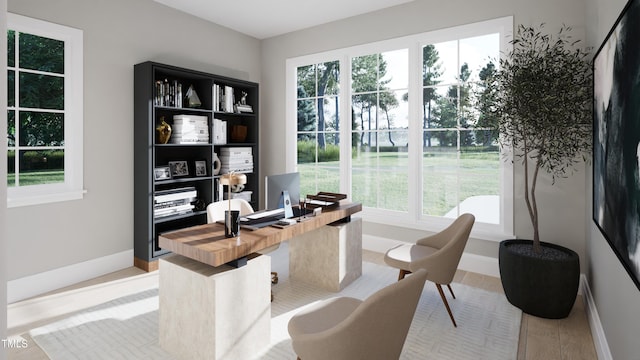 office area with a healthy amount of sunlight and light hardwood / wood-style flooring