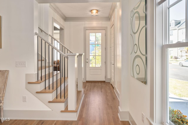 doorway featuring light hardwood / wood-style floors and crown molding