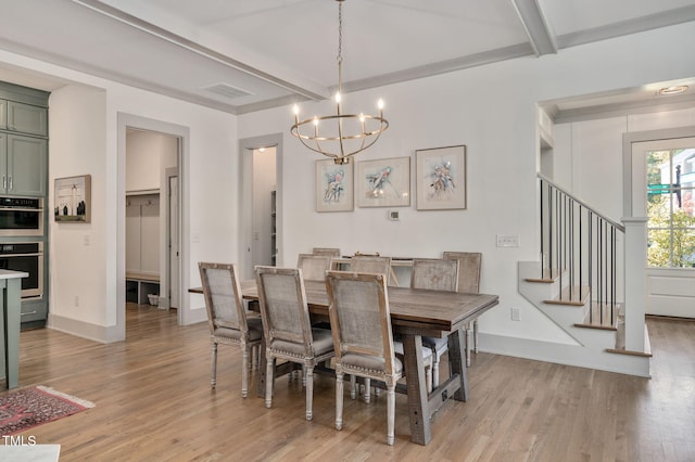 dining area featuring beam ceiling, light hardwood / wood-style floors, and a chandelier