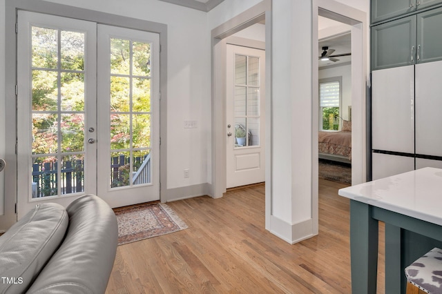 entryway with ceiling fan, light hardwood / wood-style flooring, and french doors