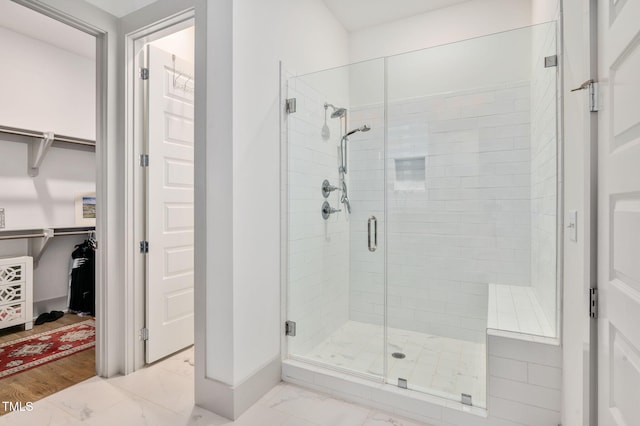 bathroom featuring a shower with door