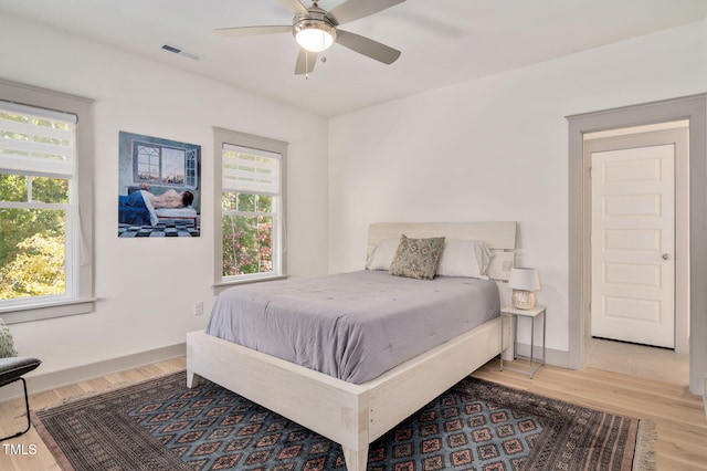 bedroom with ceiling fan and hardwood / wood-style flooring