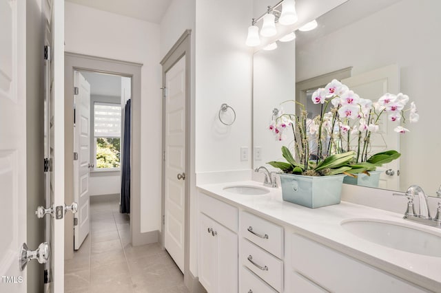 bathroom with tile patterned flooring and vanity