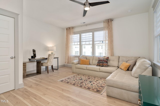 living room featuring light hardwood / wood-style floors and ceiling fan