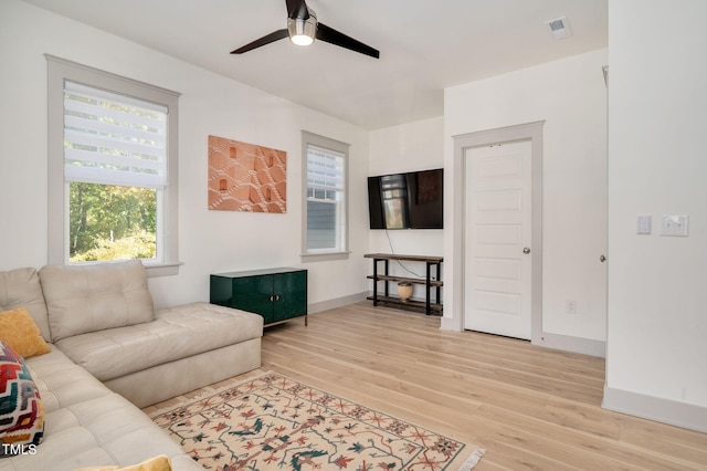 living room with ceiling fan, a healthy amount of sunlight, and light hardwood / wood-style flooring