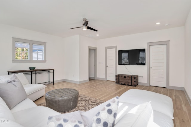 living room featuring ceiling fan and light hardwood / wood-style flooring