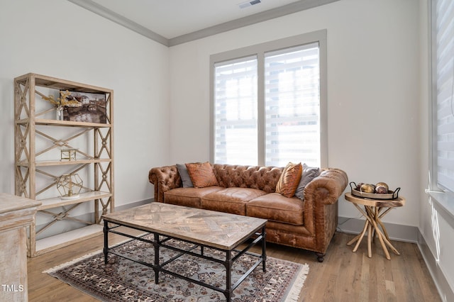 living room featuring hardwood / wood-style flooring and crown molding