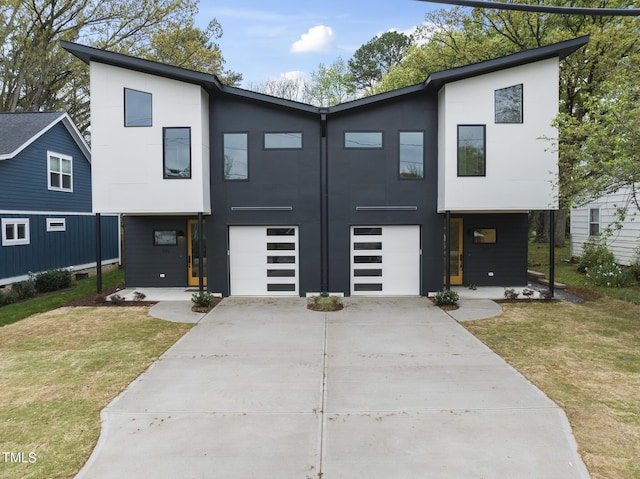 modern home featuring a front lawn and a garage