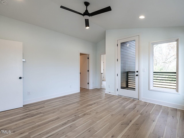 unfurnished room with ceiling fan, light wood-type flooring, and vaulted ceiling