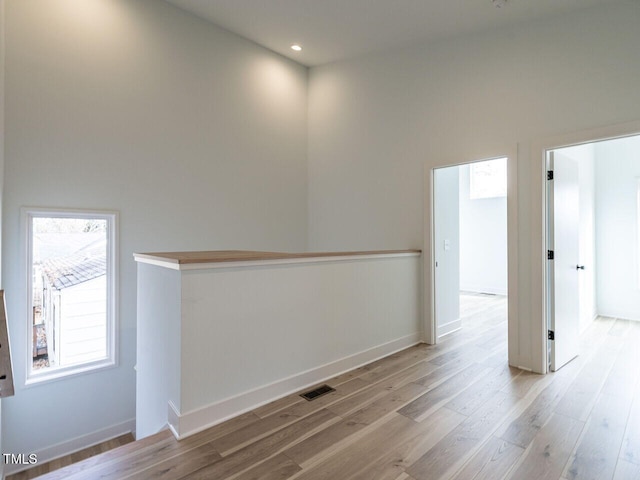 spare room with light hardwood / wood-style flooring