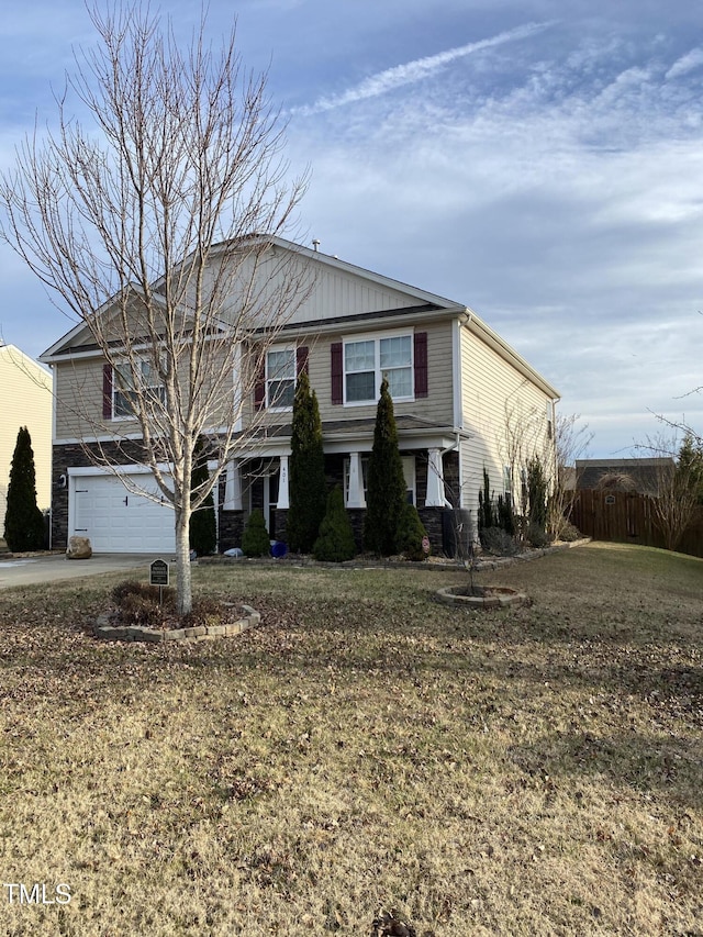 view of front facade with concrete driveway, a front lawn, and an attached garage