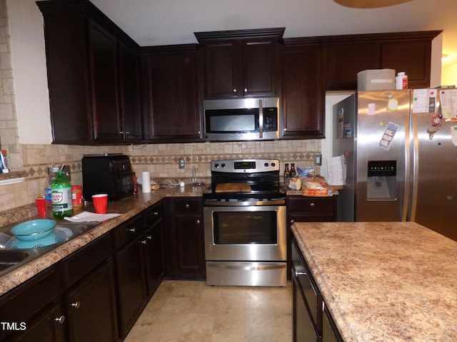 kitchen featuring appliances with stainless steel finishes, backsplash, and dark brown cabinets