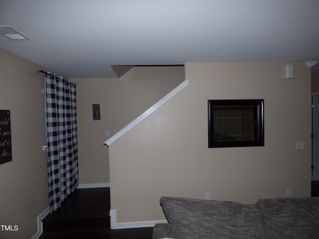 stairs featuring visible vents, baseboards, and wood finished floors