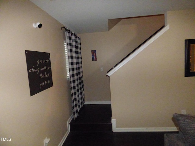 staircase featuring baseboards