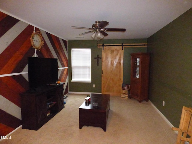 carpeted living room featuring a barn door, baseboards, and ceiling fan