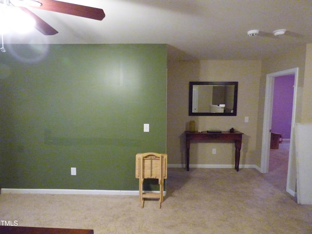 empty room featuring baseboards and a ceiling fan